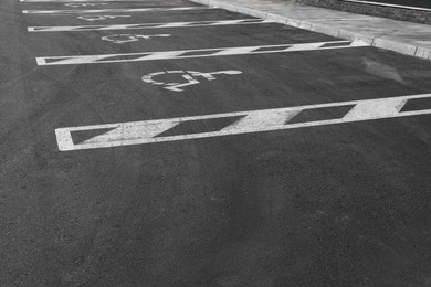 Photo of Car parking lot with wheelchair symbols outdoors