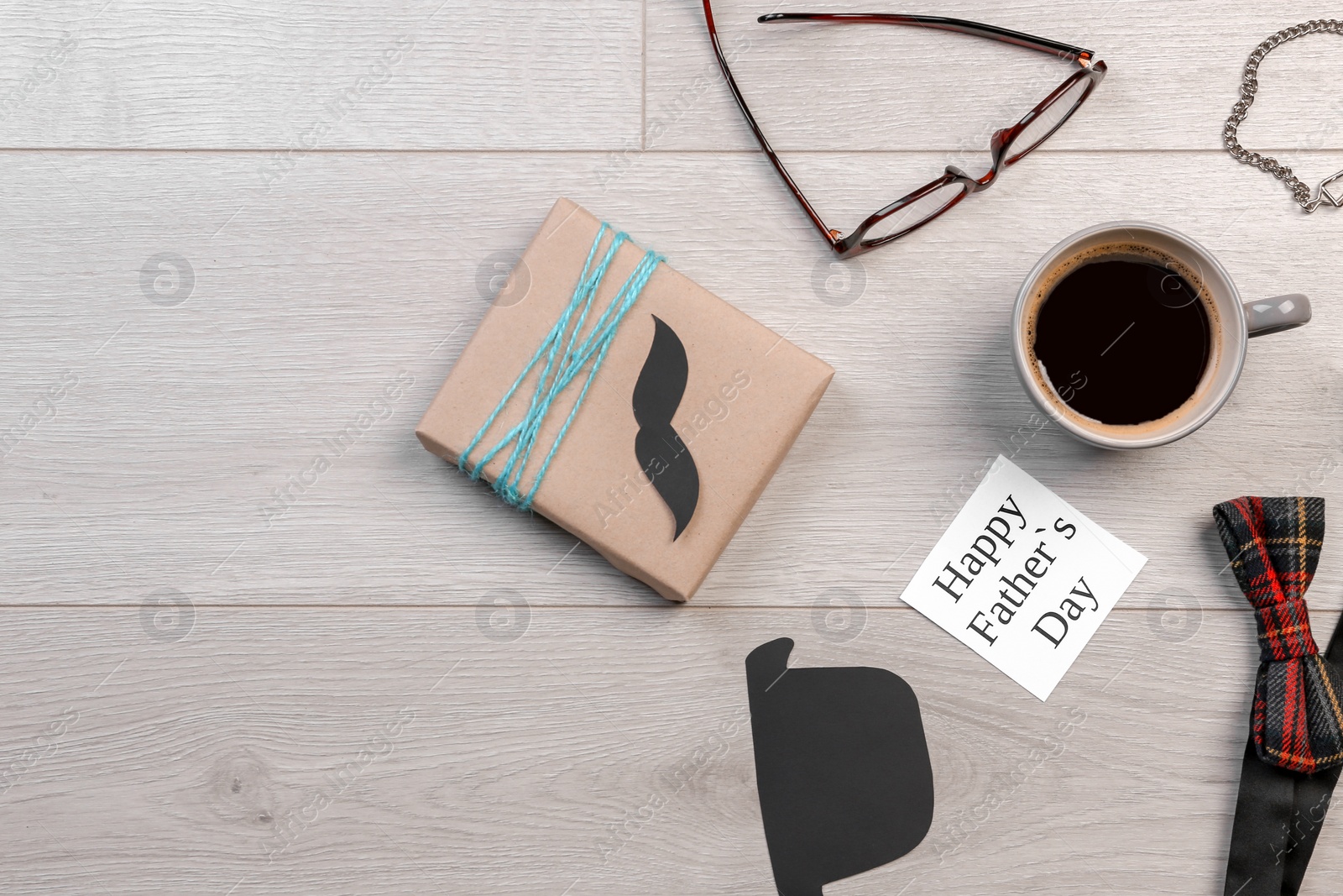 Photo of Composition with gift box and cup of coffee on wooden background. Father's day celebration