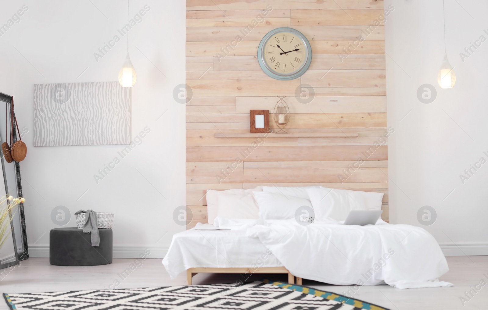 Photo of Room interior with comfortable bed near wooden wall