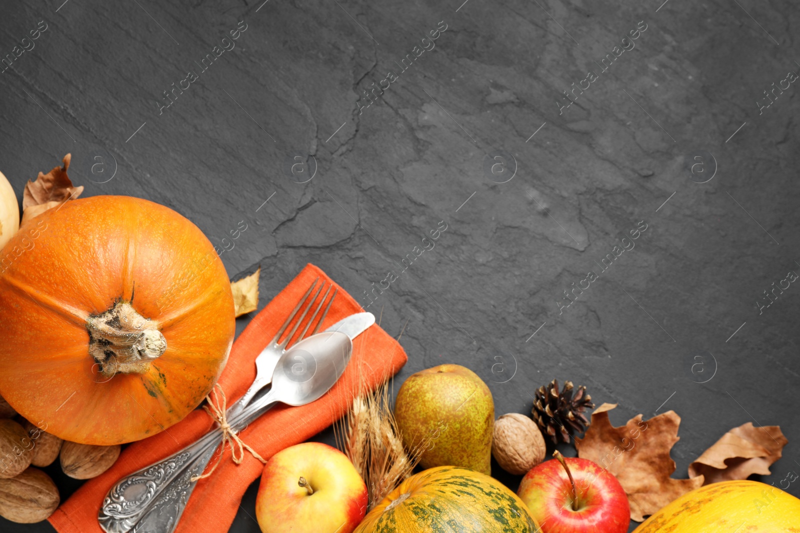 Photo of Flat lay composition with cutlery, autumn vegetables and fruits on grey background, space for text. Happy Thanksgiving day