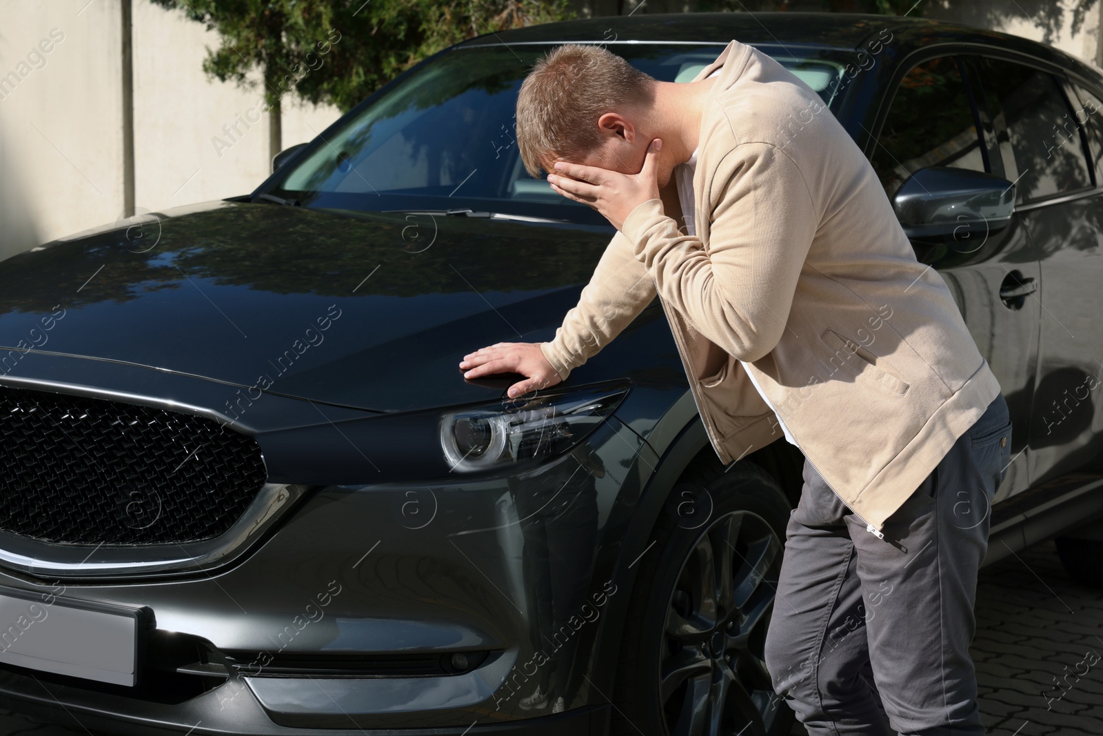 Photo of Stressed man near car with scratch outdoors