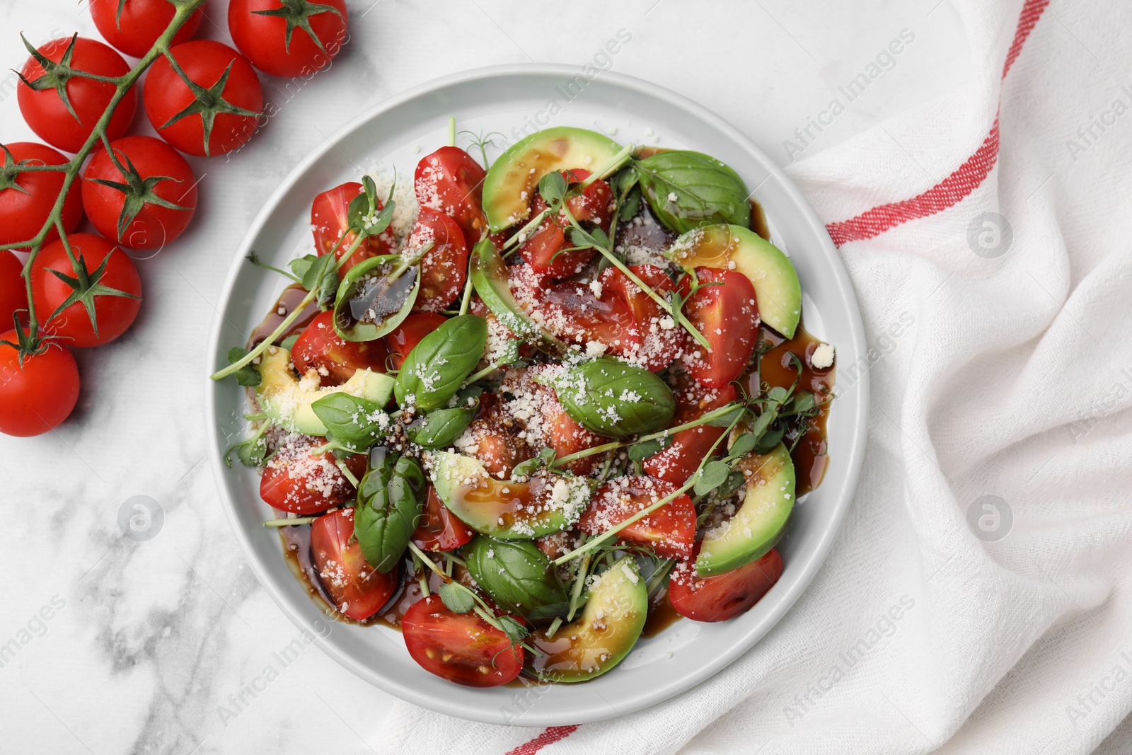 Photo of Tasty salad with balsamic vinegar on white marble table, flat lay