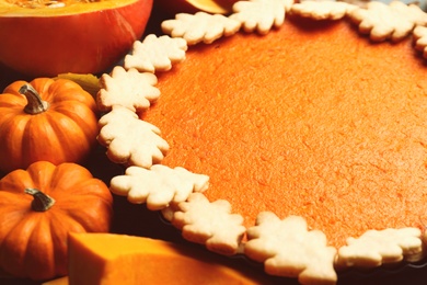 Photo of Closeup view of pumpkins and delicious homemade pie