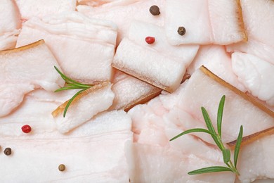 Photo of Tasty salt pork with peppercorns and rosemary, top view