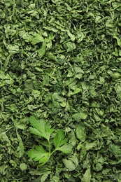 Heap of dried parsley and fresh leaf as background, closeup