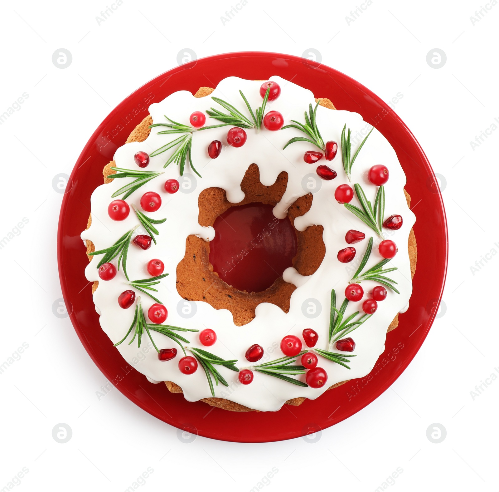 Photo of Traditional Christmas cake decorated with glaze, pomegranate seeds, cranberries and rosemary isolated on white, top view