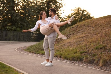 Photo of Lovely couple dancing together outdoors at sunset