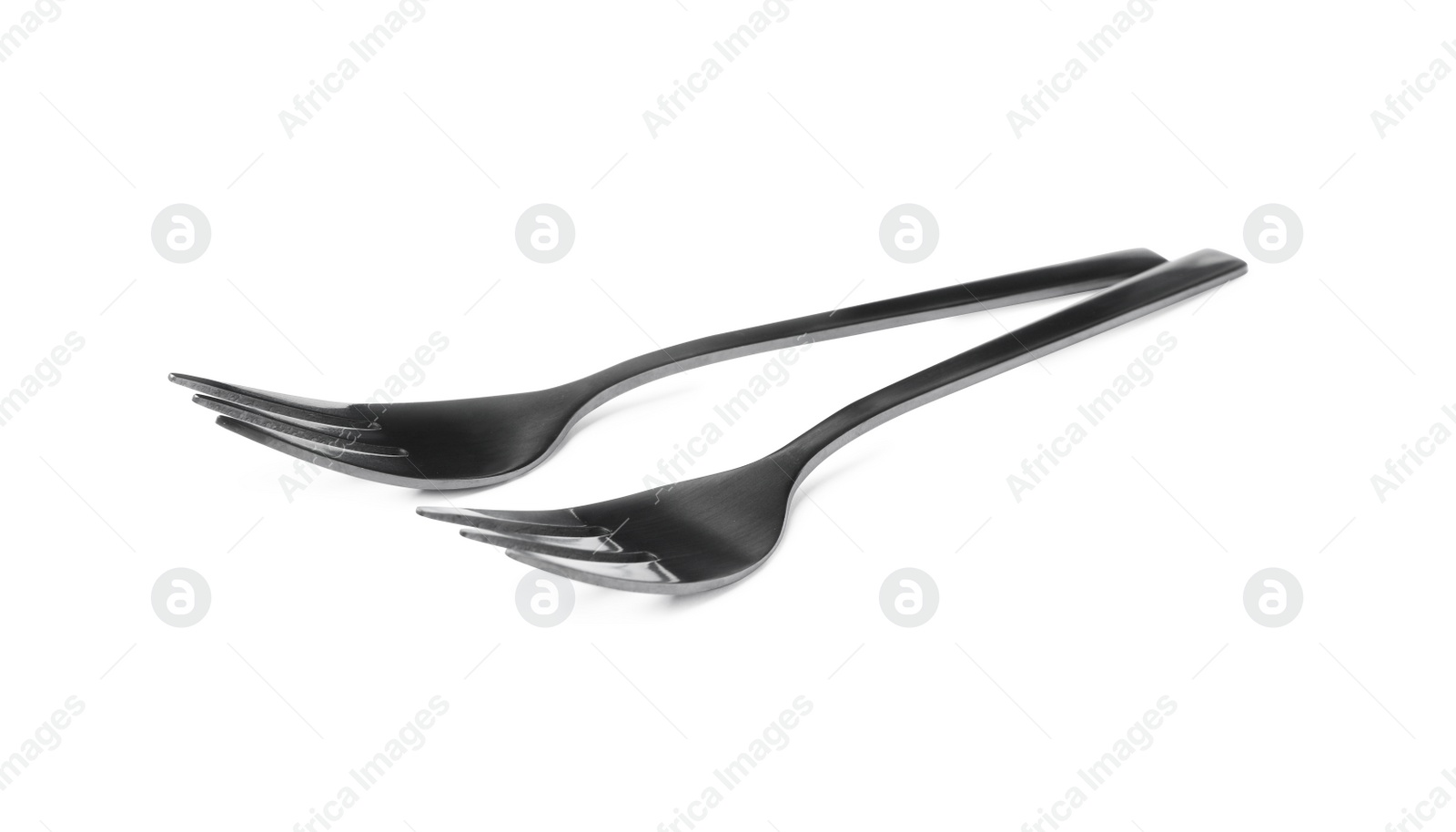 Photo of Clean shiny metal forks on white background