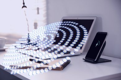 Fingerprint identification. Modern laptop and smartphone on table indoors