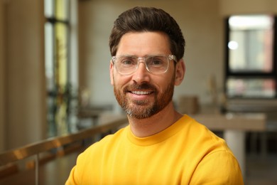 Photo of Portrait of handsome stylish man in office