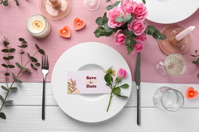 Romantic table setting with flowers and candles, flat lay