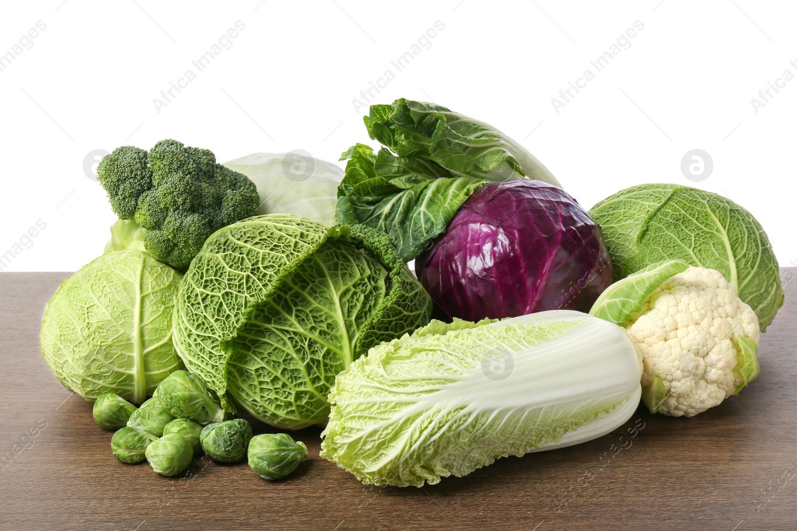 Photo of Many different fresh ripe cabbages on wooden table