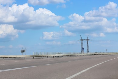 Photo of View of asphalt highway under blue sky