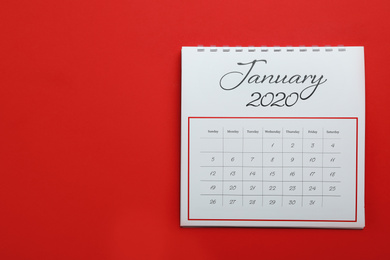 Photo of January 2020 calendar on red background, top view. Space for text