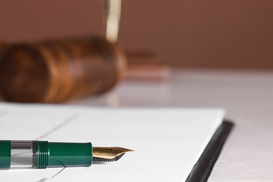 Fountain pen and paper document on table, closeup with space for text. Notary service