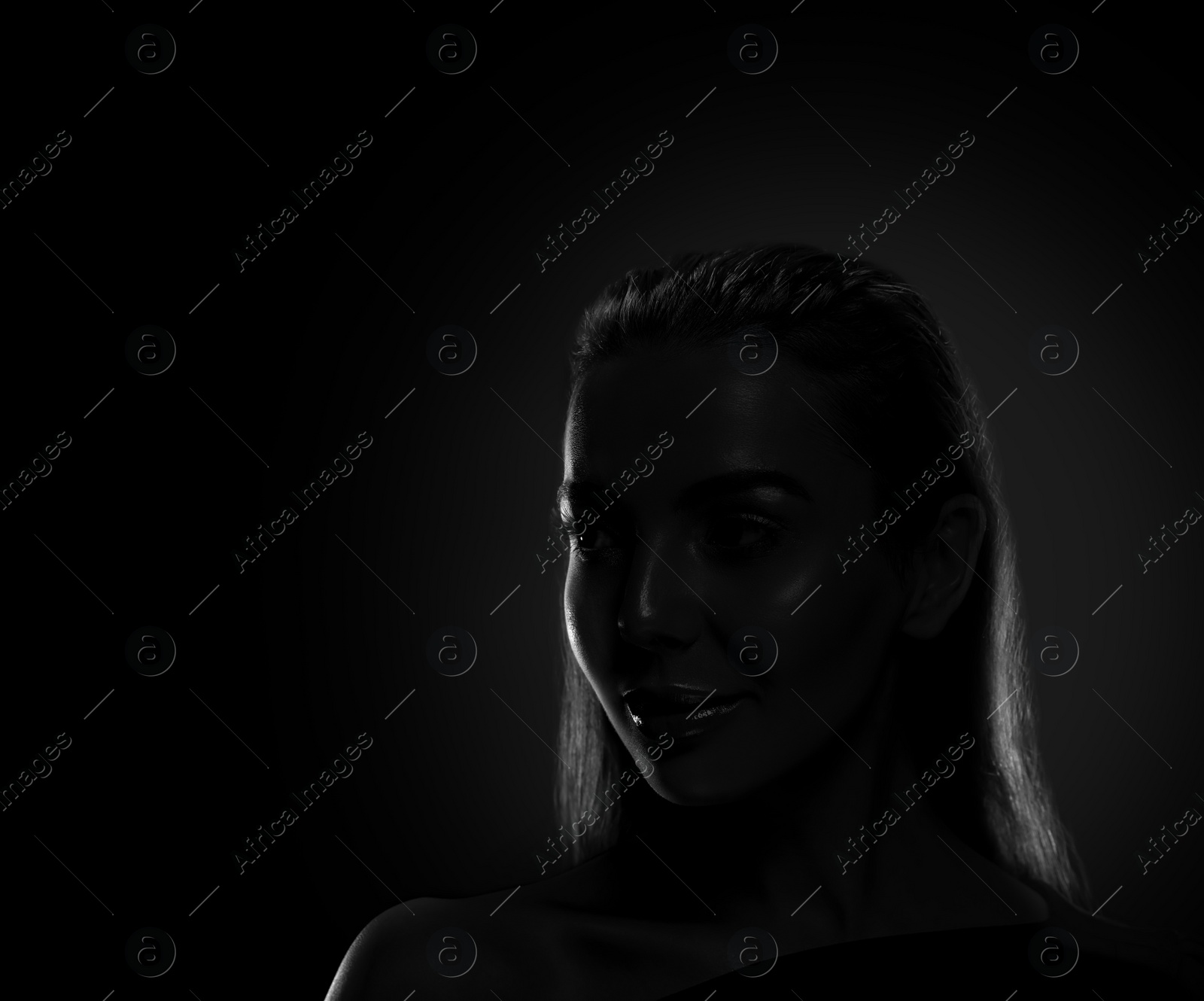 Image of Silhouette of woman in darkness. Portrait on black background