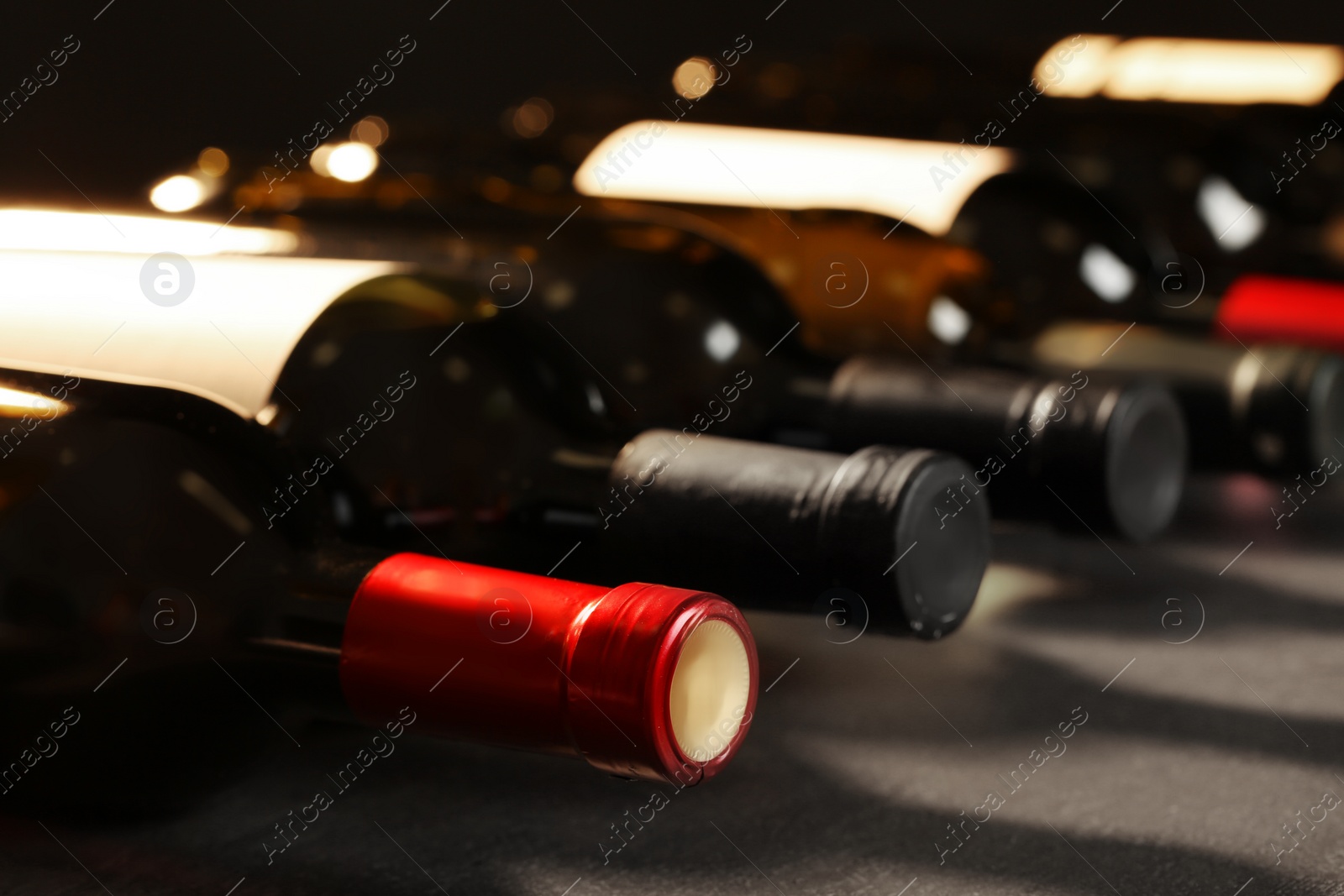 Photo of Bottles of different wines, closeup. Expensive collection