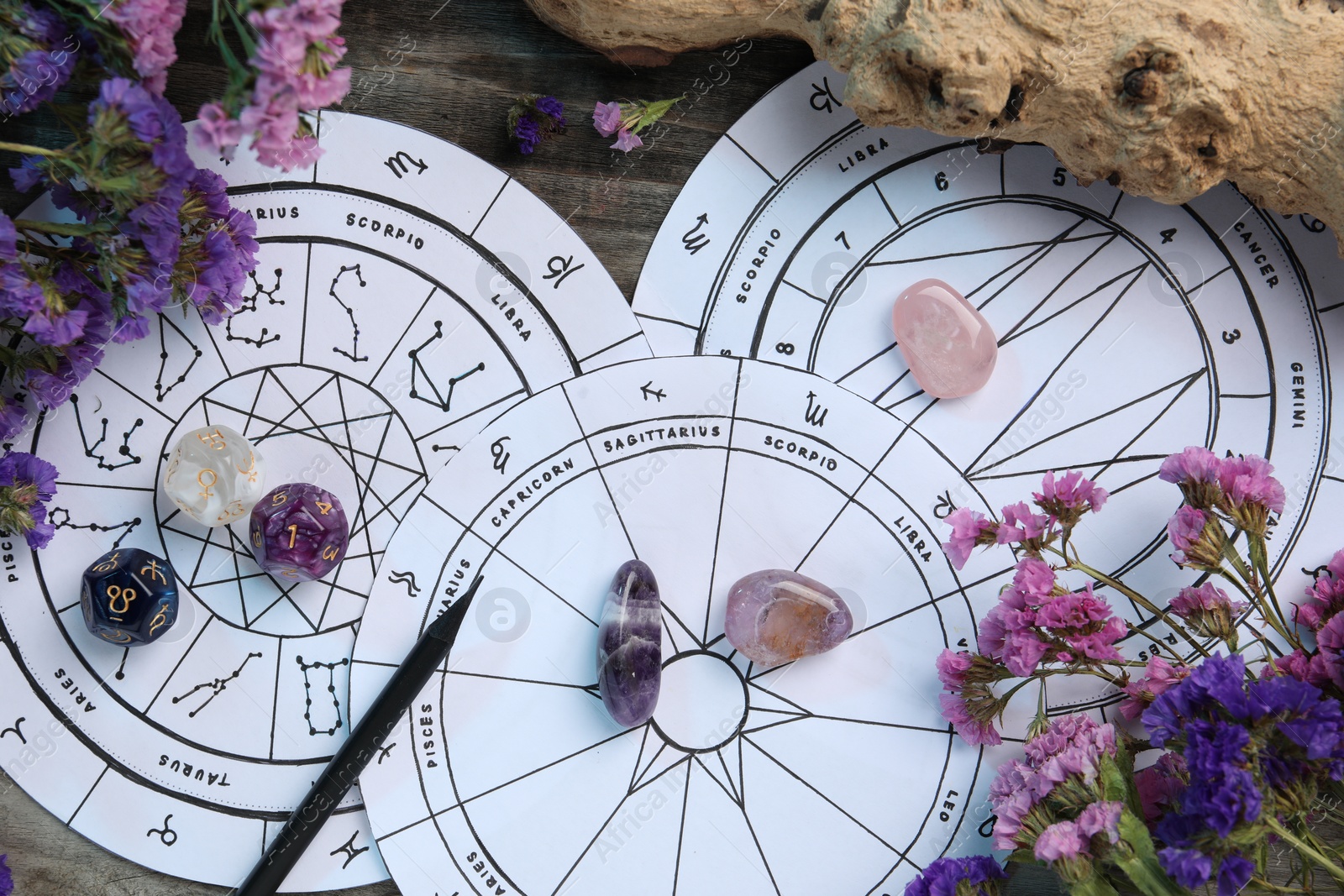 Photo of Flat lay composition with zodiac wheels and astrology dices on wooden table