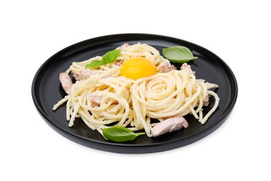 Plate of tasty pasta Carbonara with basil leaves and egg yolk isolated on white