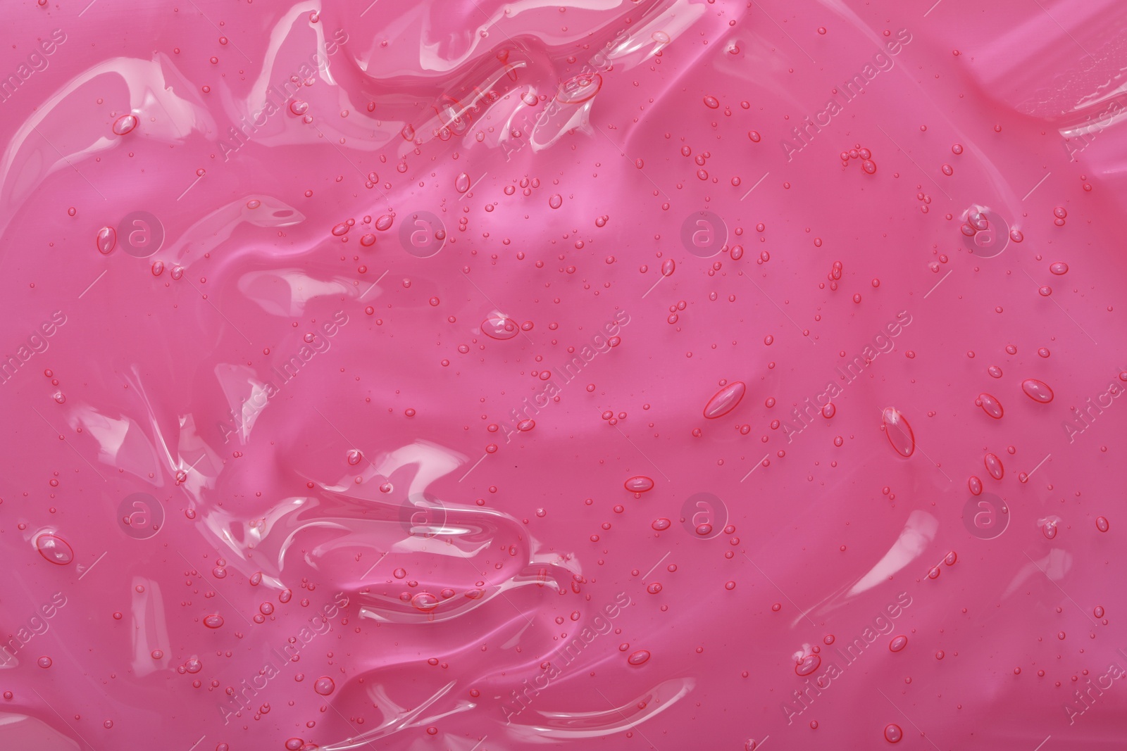 Photo of Pure transparent cosmetic gel on pink background, closeup