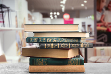 Image of Collection of different books on table against blurred background