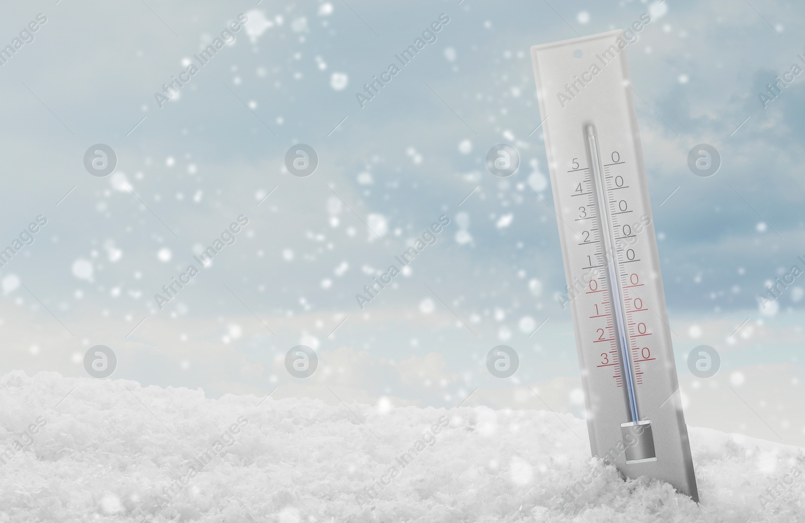 Image of Thermometer in snow showing temperature below zero outdoors on winter day