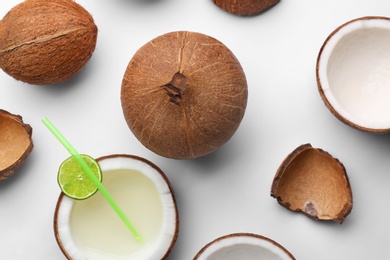 Photo of Composition with coconuts and drink on white background, top view