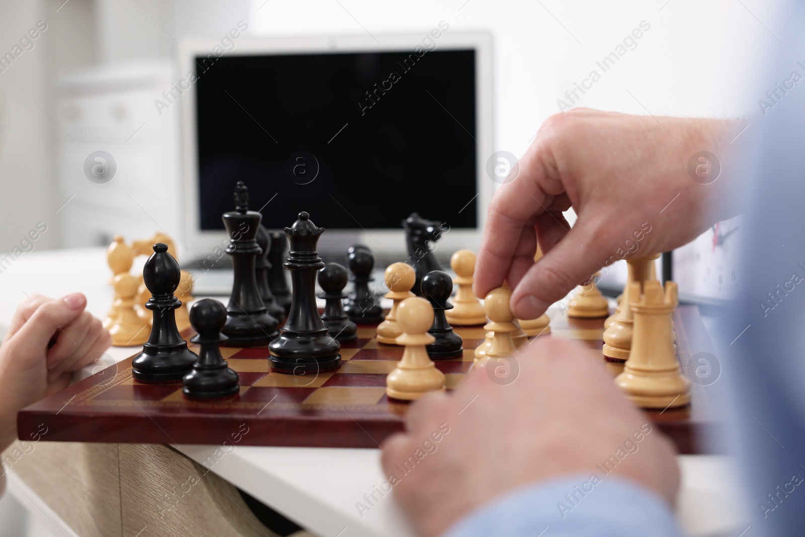 Photo of Man playing chess at table indoors, closeup