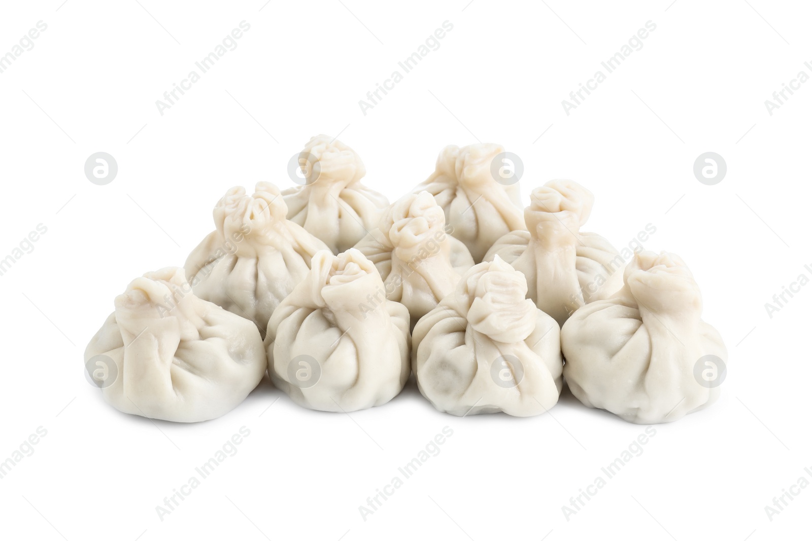 Photo of Many tasty khinkali (dumplings) isolated on white. Georgian cuisine