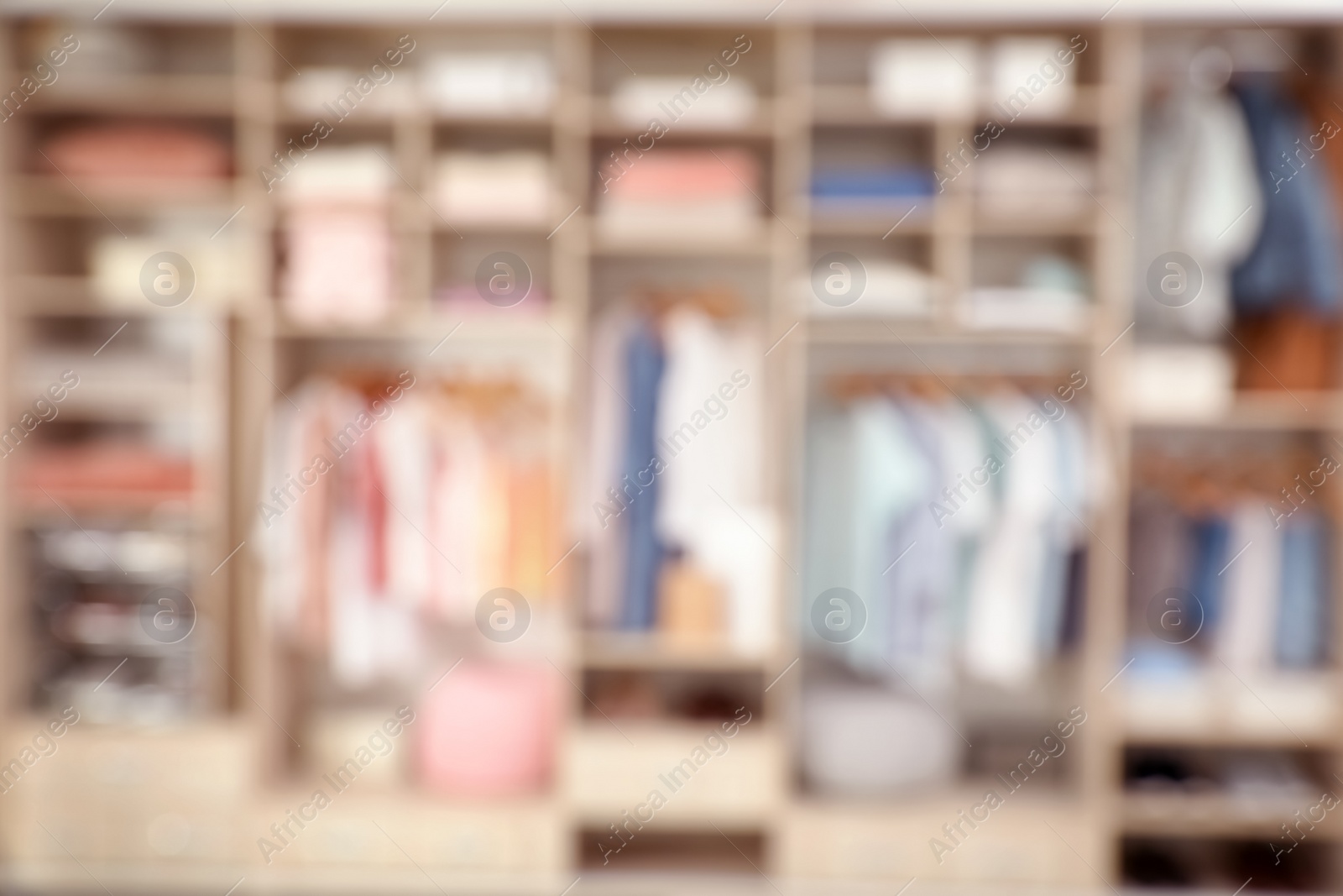 Photo of Blurred view of large wardrobe with stylish clothes