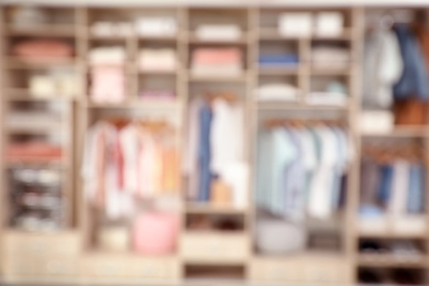 Blurred view of large wardrobe with stylish clothes