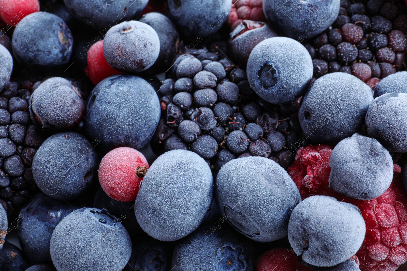 Photo of Mix of different frozen berries as background, top view