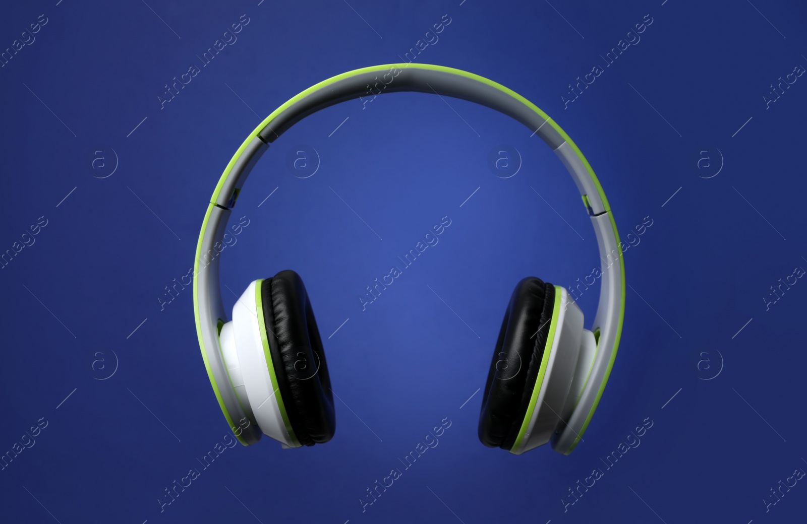 Photo of Stylish modern headphones with earmuffs on color background