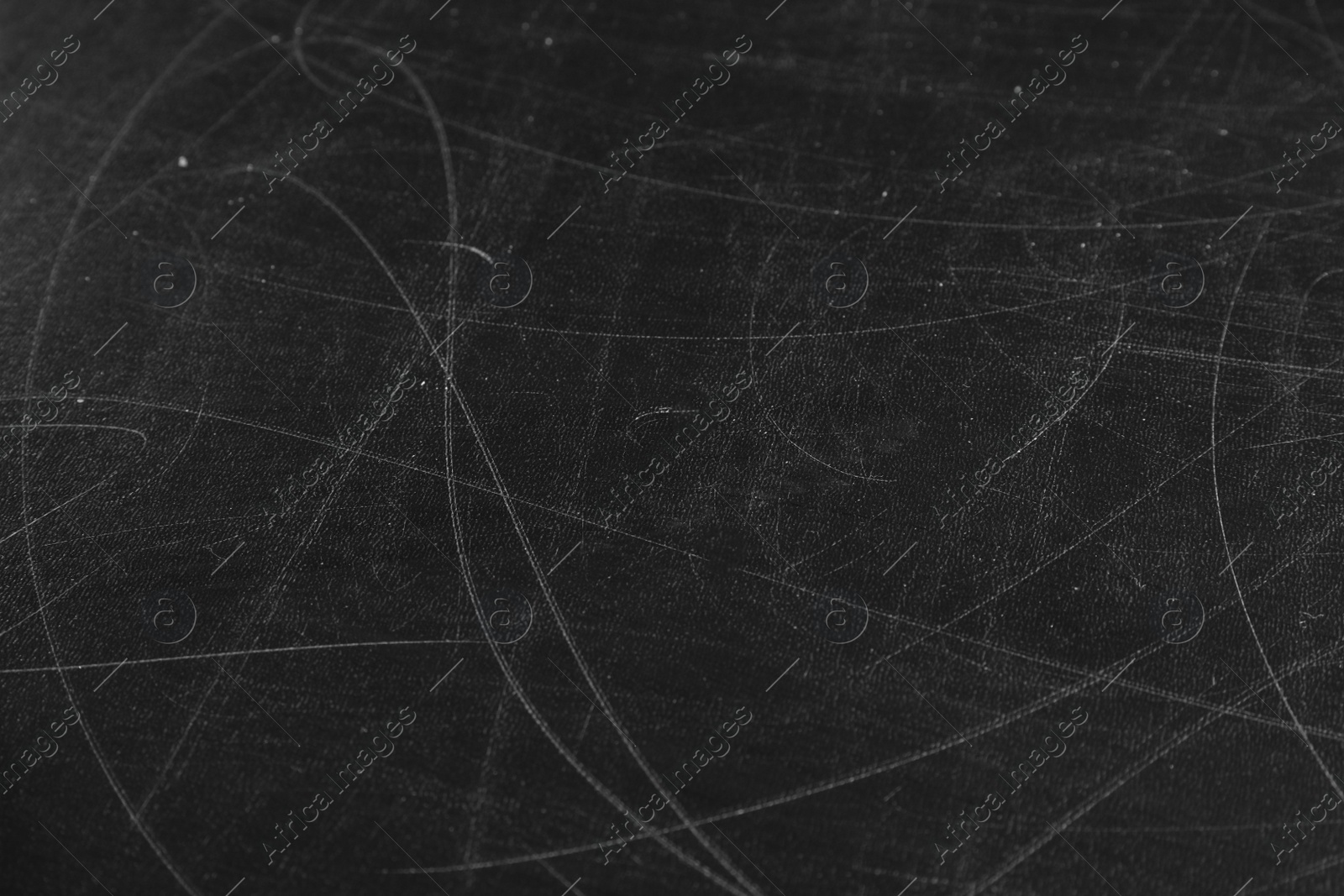 Photo of Texture of scratched black surface as background, closeup