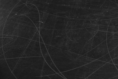 Photo of Texture of scratched black surface as background, closeup