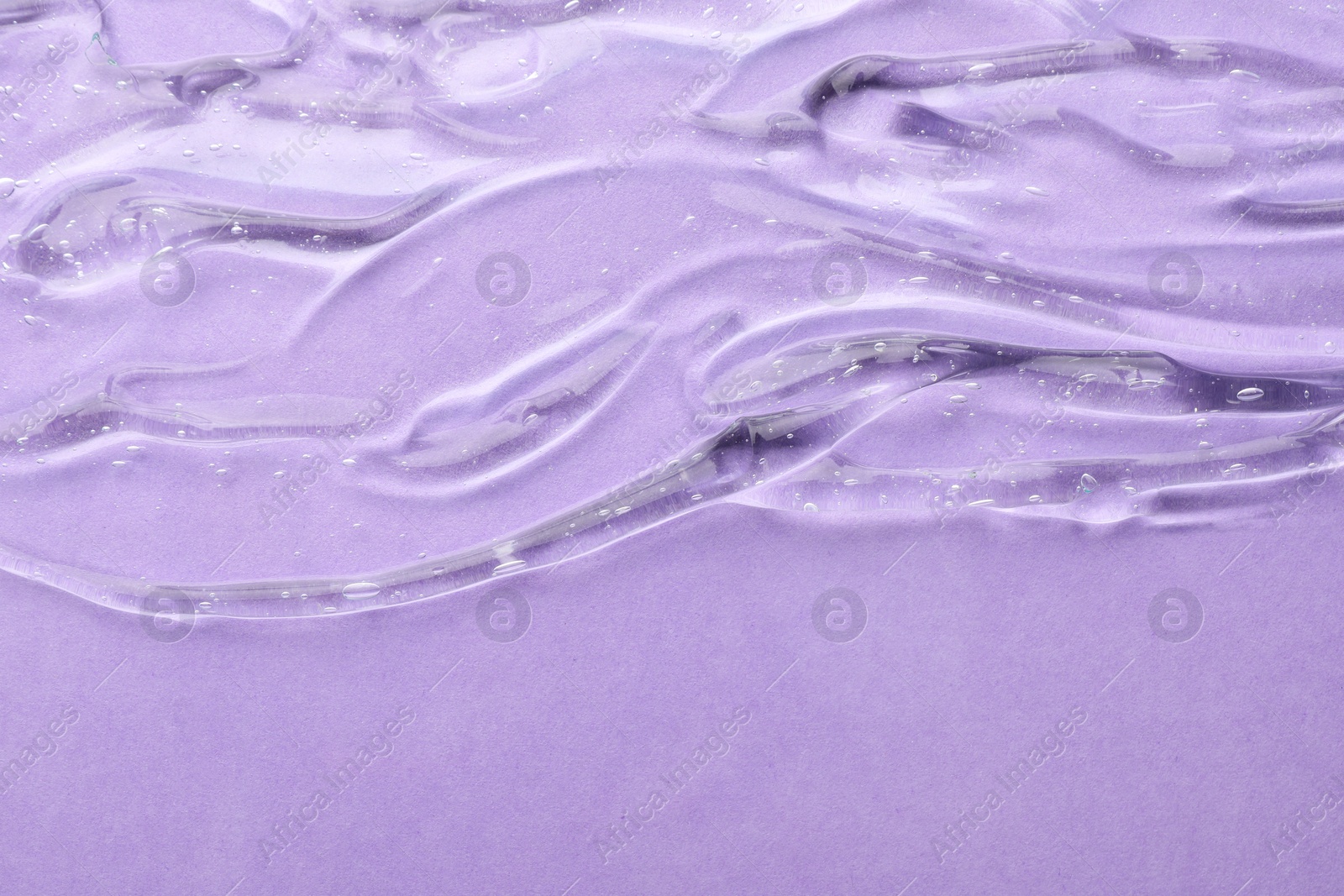 Photo of Clear cosmetic gel on violet background, top view. Space for text