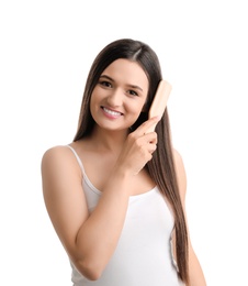 Photo of Beautiful young woman with hair brush on white background