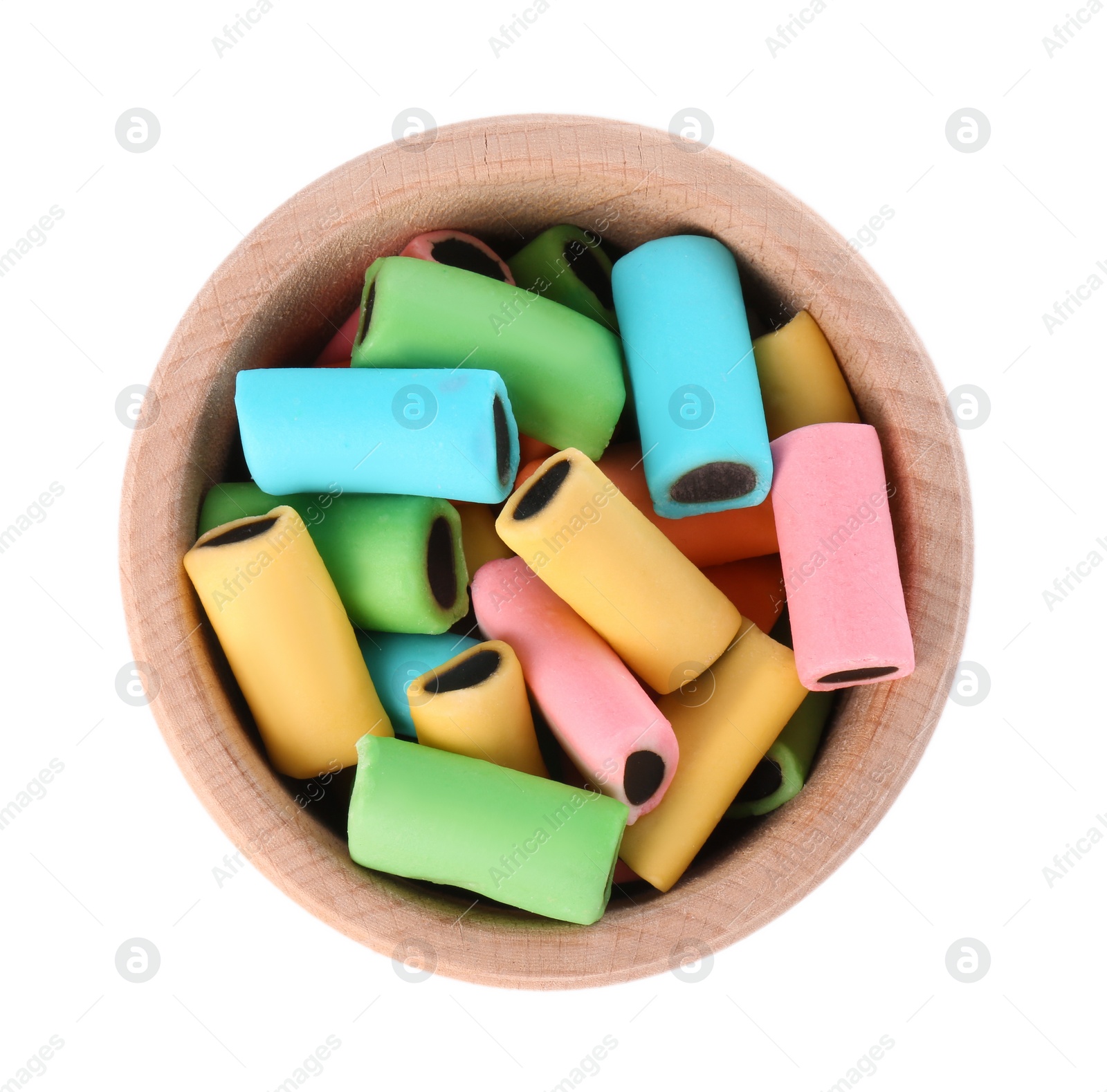 Photo of Bowl with many tasty liquorice candies isolated on white, top view