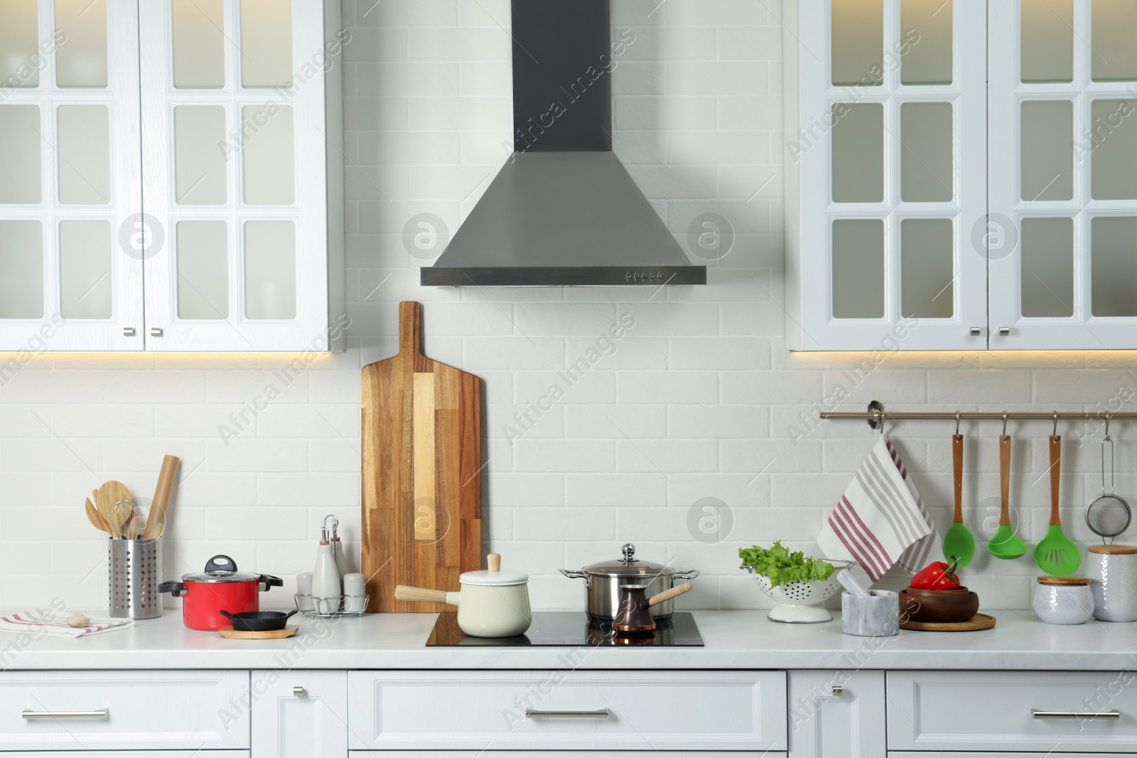 Photo of Countertop with different cooking utensils and products in kitchen