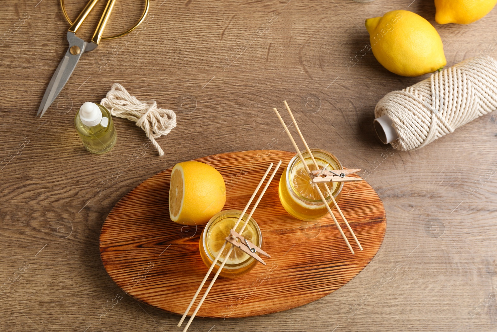 Photo of Flat lay composition with handmade citrus candles on table