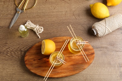 Photo of Flat lay composition with handmade citrus candles on table