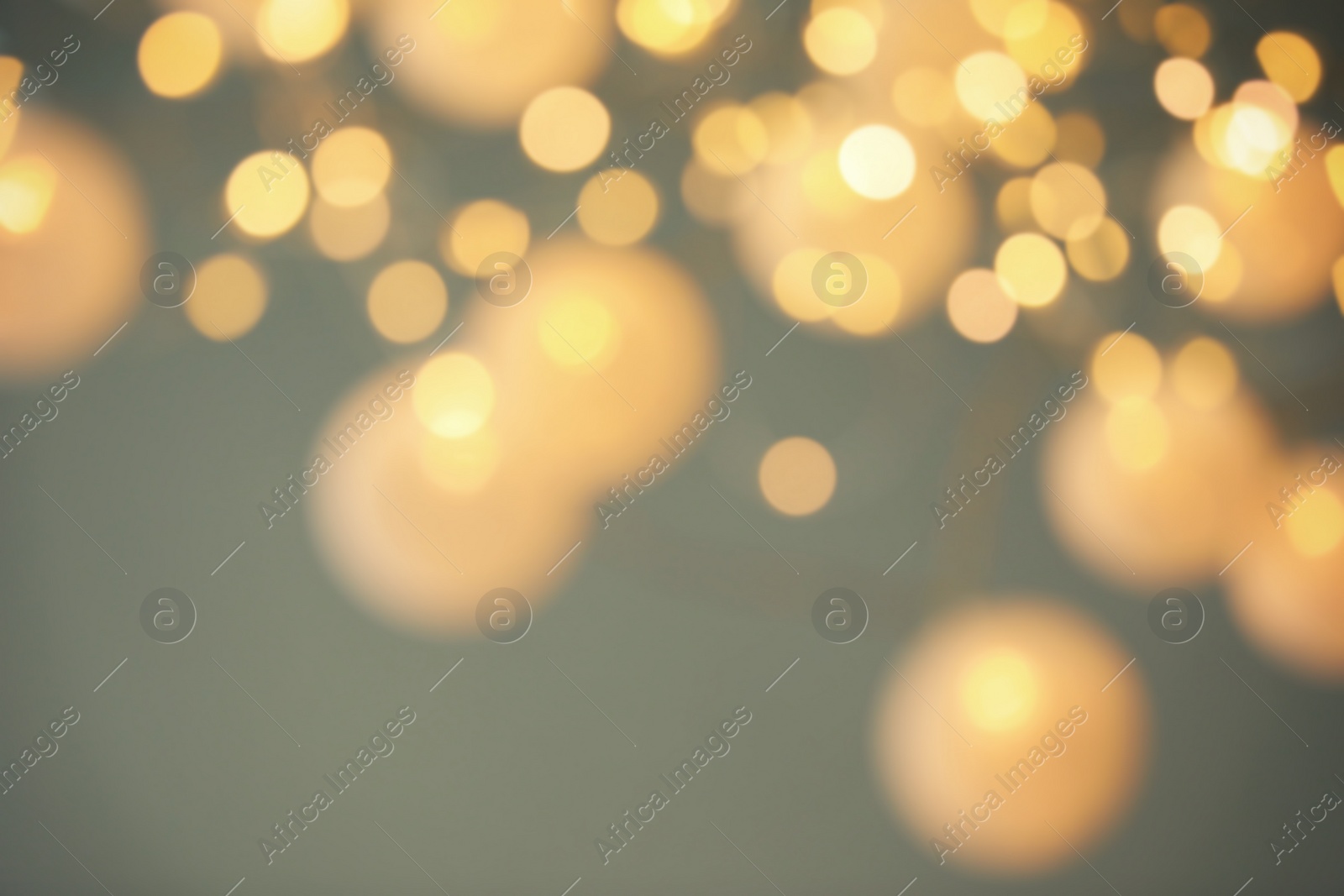 Photo of Blurred view of shiny gold lights. Bokeh effect