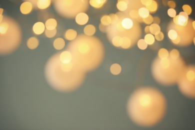 Photo of Blurred view of shiny gold lights. Bokeh effect