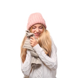 Portrait of emotional young woman in stylish hat and sweater with scarf on white background. Winter atmosphere