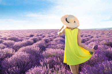 Young woman with bouquet in lavender field