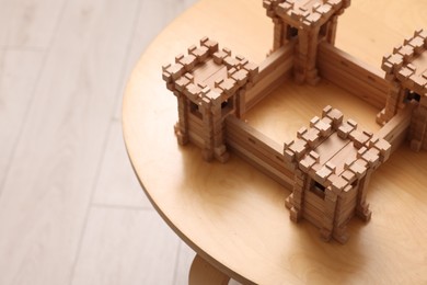 Wooden fortress on table indoors, space for text. Children's toy