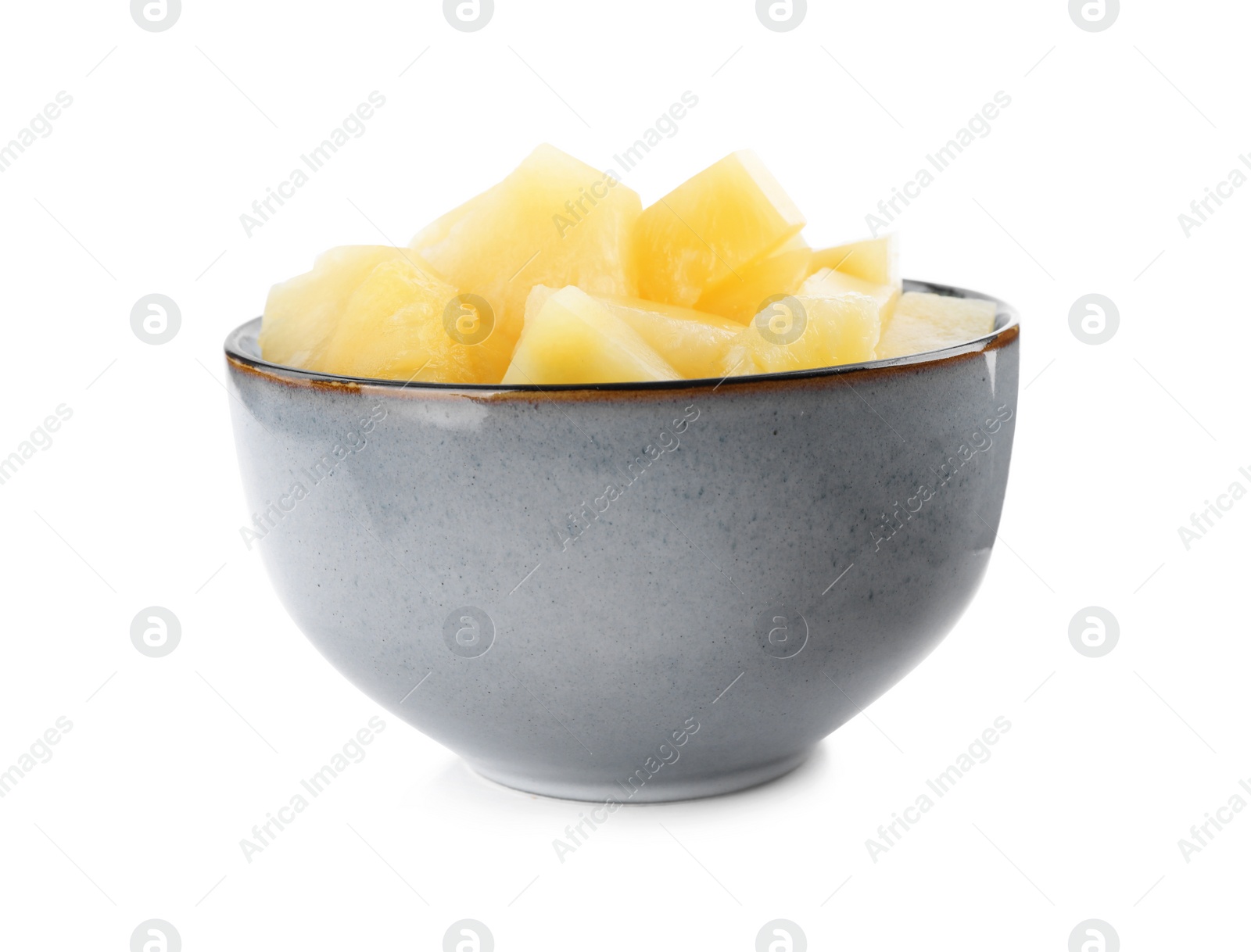 Photo of Pieces of delicious canned pineapple in bowl on white background