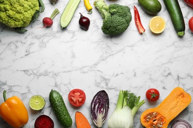 Photo of Frame made of fresh ripe vegetables and fruits on marble background, flat lay. Space for text