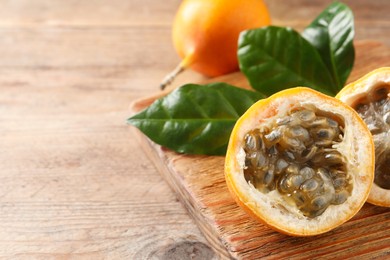 Photo of Delicious ripe granadillas on wooden table, closeup