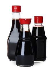 Bottles of tasty soy sauce isolated on white